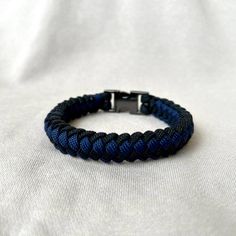 Black and Blue Braided Paracord Bracelet for Men - Stylish, Handmade, and Durable Elevate your everyday style with this handmade black and blue braided paracord bracelet, designed for men who appreciate both fashion and functionality. Crafted with high-quality paracord, this bracelet blends rugged durability with a modern, masculine look. ・ Key Features:     Material: Made from durable black and blue paracord, this black paracord bracelet is built to last. The tough paracord material ensures str Adjustable Blue Bracelets For Outdoor, Casual Blue Durable Bracelets, Black Outdoor Bracelet Jewelry, Black Bracelet Jewelry For Outdoor, Adjustable Blue Braided Bracelets For Outdoor, Adjustable Black Braided Bracelet, Durable Black Paracord Bracelets, Adjustable Black Paracord Jewelry, Casual Black Braided Bracelets For Outdoor