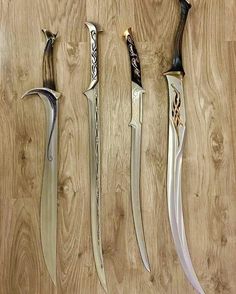 four different types of knives on a wooden surface