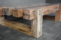 a wooden bench sitting on top of a tiled floor