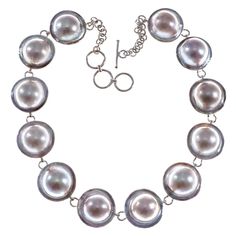 "12 Mabe Blister Pearl Chain 925 Sterling Silver Choker Necklace Mabe pearl strand necklace made with 12 stunning mabe pearls. Gorgeous pearls, excellent luster and large size. Excellent workmanship. A stunning pearl necklace that will catch plenty of compliments! Necklace Length: 15 1/2\"-16 1/2\", adjustable Pearl Size: ~14mm in 20mm shell Pendant Material: 925 sterling silver Pearl Type: Mabe blister pearl Pendant Weight: ~2.4oz" Silver Chain Anklet, Sterling Silver Choker Necklace, Pearl Strands Necklace, Sterling Silver Choker, Detailed Necklace, Silver Choker Necklace, Solitaire Pendant Necklace, Silver Choker, Sterling Silver Filigree