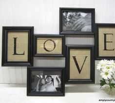 four frames with the word love on them and two flowers in front of them,