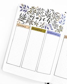 an open planner with floral designs on the pages and lined paper in front of it