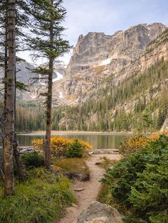 a trail leading to a lake in the mountains