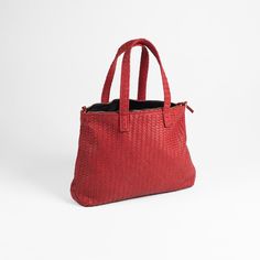 Specs 100% Real Leather. Top carry handle Pattern: Woven Design 1 zipper pocket Black Velvet Interior Color: Red Size: 45x32 cm. 1 Adjustable Shoulder Strap Zipper Closure Material: This bag is hand-woven from 100% natural leather Jild brings you exquisite hand woven pure leather ladies bag, the perfect accessory to elevate your style and complete your look. Crafted by skilled artisans, each bag is intricately woven by hand using the finest quality leather. The attention to detail is evident in the precise weaving pattern, creating a unique and beautiful texture that is sure to turn heads. The bag features a top handle and a detachable shoulder strap, giving you the option to carry it in the way that is most comfortable for you. The hardware is made from durable metal and adds a touch of s Red Intrecciato Weave Shoulder Bag For Shopping, Red Bag With Braided Handles For Errands, Red Shoulder Bag With Braided Handles For Errands, Red Intrecciato Weave Shoulder Bag, Red Tote Shoulder Bag With Intrecciato Weave, Red Leather Satchel With Zipper Pocket, Red Shoulder Bag With Braided Handles For Everyday, Red Top Handle Shoulder Bag With Braided Handles, Red Intrecciato Weave Shoulder Bag For Daily Use