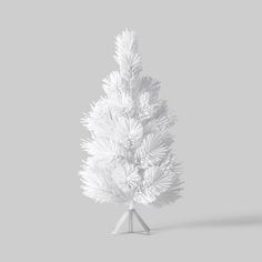 a white christmas tree on a gray background