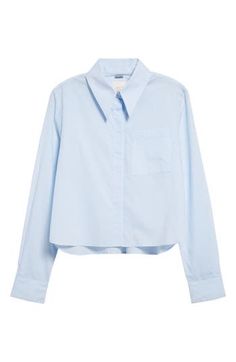 A boxy cotton button-up steps out of the office with a covered button placket and a cute cropped length. 21 1/2" length (size Medium) Front button closure Spread collar Long sleeves with button cuffs Chest patch pocket 100% cotton Dry clean Made in the USA Trendy Cropped Shirt For Work, Chic Cropped Shirt With Collar For Work, Cotton Cropped Shirt With Button Cuffs For Spring, Cotton Cropped Shirt With Buttons For Daywear, Cropped Blue Blouse For Work, Blue Cropped Blouse For Work, Button-up Cropped Shirt With Button Cuffs For Work, Cotton Button-up Cropped Shirt For Daywear, Cotton Cropped Button-up Shirt For Daywear