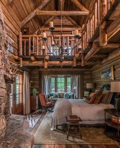 a bedroom with wooden walls and ceiling beams