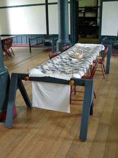 a long table is set up in an empty room