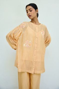 Peach sheer top featuring floral hand embroidery all over with drop shoulders and front button placket. Comes with an inner. - Aza Fashions Orange Sets With Resham Embroidery For Spring, Spring Orange Sets With Resham Embroidery, Orange Resham Embroidery Sets For Spring, Spring Orange Resham Embroidery Sets, Peach Blouse Piece With Resham Embroidery, Summer Embroidered Top With Blouson Sleeves, Orange Long Sleeve Tops For Festive Season, Orange Blouse With Floral Embroidery, Summer Tops With Embroidered Sleeves For Daywear