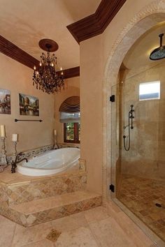 a bathroom with a large tub and chandelier