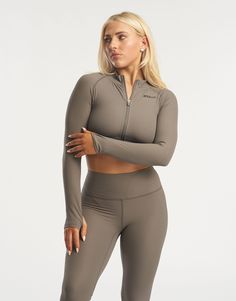 The Rise series awakes - taking ECHT's seamless fabric to a new level. This cropped long sleeve is made of a soft and flexible ribbed fabric and sits comfortably across the waist to accentuate your silhouette. Featuring full zip from collar to waist to keep you warm or cool, thumb holes and advanced heat pressed silicone ECHT logo. The Rise Zip up long sleeve paired with marching Rise Leggings is suitable for all day wear and low intensity workouts. - Seamless fabric with a ribbed structure - Sweat-wicking and breathable - Super soft peach-like sensation feel - Thumb holes to keep fingers warm - Cropped waist length - Zip from collar to waist 76% Nylon, 24% Spandex Phoebe is wearing a Small, and is 5'4" Seamless Fitted Long Sleeve Activewear, Versatile Seamless Long Sleeve Activewear, Functional Long Sleeve Crop Top For Workout, Ribbed Long Sleeve Sports Activewear, Compression Long Sleeve Crop Top For Workout, Winter Cropped Stretch Activewear, Functional Long Sleeve Stretch Crop Top, Stretch Cropped Activewear For Winter, Long Sleeve Stretch Crop Top