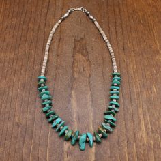 Vintage 19" turquoise and heishi necklace. There are 30 pieces of turquoise with matrix. The longest turquoise is 3/4". The shortest 1/2". The back has round and melon sterling beads and a sterling hook clasp. The necklace is in good condition. Thank you for shopping in our store. Please let us know if you have questions.  NECK-1335K-NK-14 k *The color you see on your screen may not reflect the actual stone color due to variations in monitors* Adjustable Artisan Turquoise Heishi Beads Necklace, Adjustable Artisan Turquoise Necklace With Heishi Beads, Southwestern Turquoise Heishi Beads Jewelry, Olive Shell, Heishi Necklace, Wire Cuff, Navajo Pearls, Silver Bells, Silver Chain Style