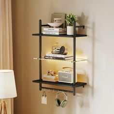 a shelf with books and headphones on it next to a lamp in a room