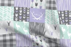 an image of a plaid fabric with deer and arrows on the pattern in pastel colors