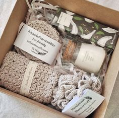 an open box with some items in it on a tablecloth covered surface and the contents are wrapped in twine