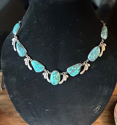 Sterling older Natural gorgeous large Turquoise Statement Necklace (I believe it is a unique studio made Mexican creation) that works with Southwestern , Mexican, contemporary jewelers and with gorgeous bright color.  Each baroque natural Turquoise is bezel set with stylized sterling links between the stones.  I've not seen another like it; what a  vision to see it worn.  Condition I see no problems, nice decorated box clasp, quality made-photos show the details.  Length approx. 20", center is approx. 1 1/4" wide, wt.- approx. 100 grams.  This is a Stunning artist hand wrought vintage Treasure. Artisan Turquoise Necklace, Artisan Turquoise Gemstone Necklace, One Of A Kind Southwestern Turquoise Jewelry, Distinctive Turquoise Gemstone Necklace, Unique Turquoise Gemstone Necklace, Artisan Turquoise Necklace With Large Stone, Collectible Turquoise Jewelry With Patina, Bohemian Natural Stones Collectible Necklaces, Handmade Turquoise Necklace For Collectors