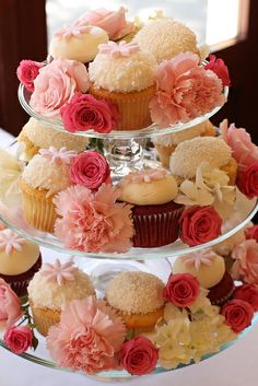 three tiered cupcake display with pink and yellow flowers