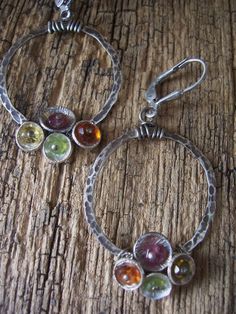 These super sweet colorful sterling silver gemstone hoop earrings from the Tiny Bubbles Collection feature multi-colored gemstones. They are hand textured sterling silver hoops are dotted with sterling silver cups and filled with peridot, carnelian , citrine and pink tourmaline. The hoops are 1' in diameter and are hung from oxidized sterling silver leverbacks. They come in a gift box perrfect for gift giving or safe keeping. Gemstone Hoop Earrings, Natural Stone Earrings, Sterling Silver Hoops, Oxidized Sterling Silver, Silver Hoops, Stone Earrings, Bohemian Jewelry, Pink Tourmaline, Jewelry Earrings Hoops