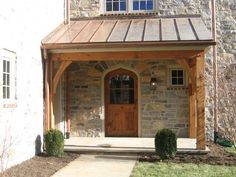 a stone house with a wooden front door