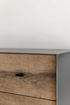 a close up of a wooden dresser with metal handles