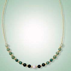 This dainty necklace is expertly crafted with beautiful jade beads of varying green shades and one delicate lavender jade focal bead in the center. The result is a stunning piece that exudes elegance and captures the eye. Mint, green, black and lavender jade (6mm) Length: 18" SELECT METAL Elegant Green Jade Crystal Necklace, Elegant Jade Crystal Necklaces With Round Beads, Elegant Beaded Jade Crystal Necklaces, Elegant Jade Crystal Necklace With Round Beads, Elegant Beaded Jade Crystal Necklace, Green Aventurine Bead Necklace, Elegant Green Crystal Necklace With Natural Stones, Green Jade Gemstone Beaded Necklace, Elegant Jade Necklace For Healing