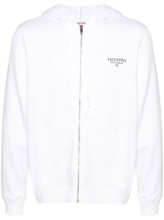 Valentino Ready To Wear white cotton blend logo print at the chest drawstring hood front zip fastening long sleeves ribbed cuffs and hem front pouch pocket French terry lining Valentino Logo, City Shorts, Balenciaga Triple S, Type Of Pants, Knitwear Men, Summer Beach Wear, White Hoodie, White Sweaters, Light Jacket