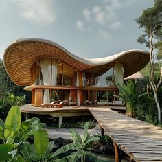 an unusual house in the middle of some trees and water with a wooden walkway leading up to it