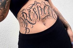 a woman with tattoos on her stomach