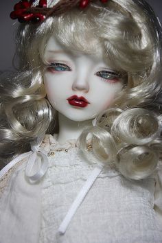 a close up of a doll with blonde hair