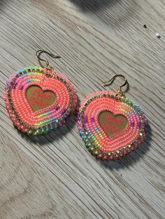 Beaded Mama Bear earrings made with neon colors Rainbow Party Earrings With Colorful Beads, Handmade Rainbow Beaded Earrings For Party, Fun Beaded Earrings For Festival, Fun Rainbow Beaded Earrings, Trendy Rainbow Round Bead Earrings, Multicolor Heart-shaped Beaded Earrings, Fun Neon Earrings For Gifts, Trendy Handmade Rainbow Beaded Earrings, Colorful Round Bead Earrings For Party