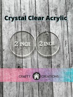 two clear acrylic circles with the words crafty creations in front of them