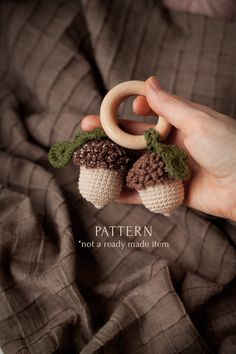 a person holding two crocheted strawberries in their hands with the words pattern not a ready made item