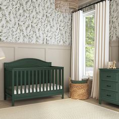 a baby's room with a green crib, dressers and a window