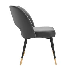 an upholstered grey chair with gold legs