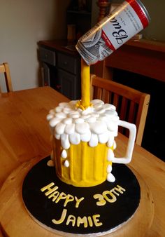 a birthday cake made to look like a beer mug with marshmallows on it