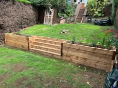 a wooden garden bed in the middle of a yard