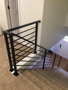 a stair case with metal railing and handrail