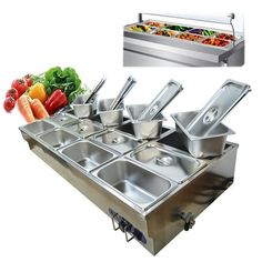 stainless steel buffet table with six pans and vegetables