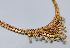 "22 k solid gold and pearl beads necklace choker from rajasthan india. detailed handcrafted, great piece for any collection. total length-15\"(we can adjust length), width of center-2.4 cm(inc. dangles), weight-17 grams. material-solid 22 k gold." Navratri 22k Gold Kundan Necklace, Festive 22k Gold Pearl Necklace With Tilla Details, Traditional 22k Gold Pearl Necklace For Festive Occasions, Gold Chandbali Pearl Necklace With Heavy Detail, Heavy Gold Chandbali Pearl Necklace, Traditional Gold Kundan Pearl Necklace, Traditional Kundan Gold Pearl Necklace, Diwali 22k Gold Temple Jewelry Pearl Necklace, Festive 22k Gold Pearl Necklace With Intricate Design