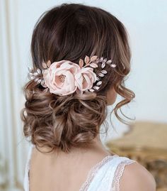 a woman wearing a hair comb with flowers on it's head and in the back