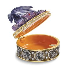 an orange and silver box with a dragon in it's lid on a white background