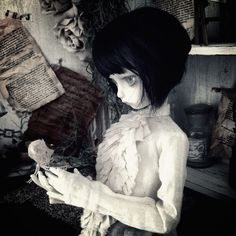 a creepy doll is holding something in her hands