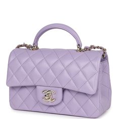 This mini Chanel rectangular flap bag with top handle is in lilac lambskin with light gold tone hardware has a front flap with signature CC turnlock closure, rear half moon pocket, top handle and single interwoven lilac leather and light gold tone chain link shoulder/crossbody strap.The interior is lined in lilac leather and features a zipper pocket with Chanel pull and an open pocket below.Collection: 24POrigin: FranceCondition: New and never worn (plastic on hardware)Accompanied by: Chanel box, Chanel dustbag, carebook, RFID, retail UPC, ribbon and feltMeasurements: 8.5" width x 6" height x 3" depth; 1.77" top handle, 22.5" strap drop Mini Chanel, Chanel Mini Rectangular, Chanel Box, Purple Bag, Chanel Mini, Top Handbags, Iconic Bags, Pocket Top, Chic Handbags