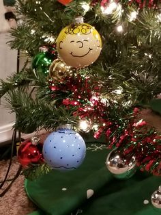 a christmas tree with ornaments on it and other decorations around the tree in front of it