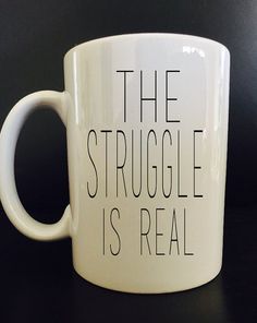 a white coffee mug with the words, the struggle is real on it