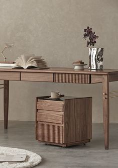 a wooden desk with two drawers and an open book on top