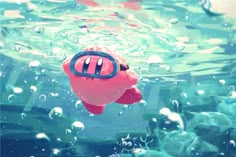 a pink toy floating in the water with bubbles on it's side and eyes open