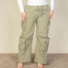 Elevate Your Wardrobe With Our Plus Size Flap Pockets Drawstring Ruched Parachute Pants, A Versatile And Stylish Addition To Your Collection. Crafted From 100% Nylon, These Pants Offer A Lightweight And Non-Stretch Woven Fabric, Ensuring Both Comfort And Durability. Key Features: - Fabric: Made From High-Quality Nylon For A Comfortable And Breathable Feel. - Fit: Available In Sizes 1xl, 2xl, And 3xl To Cater To A Variety Of Body Types. - Color Options: Choose From A Chic Olive Green Hue. - Desig Spring Khaki Pants With Drawstring, Spring Khaki Drawstring Pants, Khaki Bottoms With Drawstring For Spring, Khaki Drawstring Bottoms For Spring, Spring Khaki Drawstring Cargo Pants, Spring Khaki Bottoms With Drawstring, Spring Khaki Drawstring Bottoms, Khaki Summer Parachute Pants With Drawstring, Khaki Parachute Pants With Drawstring For Summer