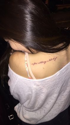 the back of a woman's shoulder with an inscription on it