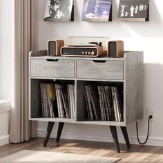 an old record player is sitting on top of a bookcase with records in it